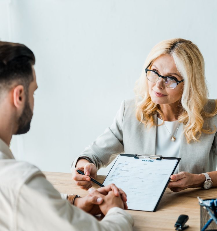 selective-focus-of-recruiter-in-glasses-holding-pen-near-clipboard-and-looking-at-bearded-man.jpg selective-focus-of-recruiter-in-glasses-holding-pen-near-clipboard-and-looking-at-bearded-man.jpg